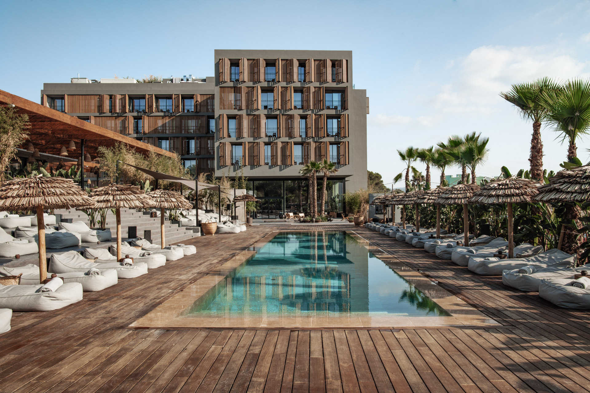 OKU Ibiza luxury five-star hotel swimming pool sunbeds DJ live music food cocktails friendly service